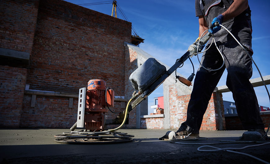 male-worker-using-concrete-screed-machine-construction-site.jpg
