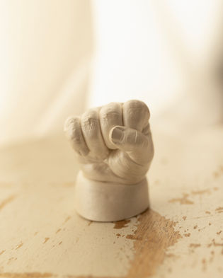 Baby hand casting painted in a white pearl paint