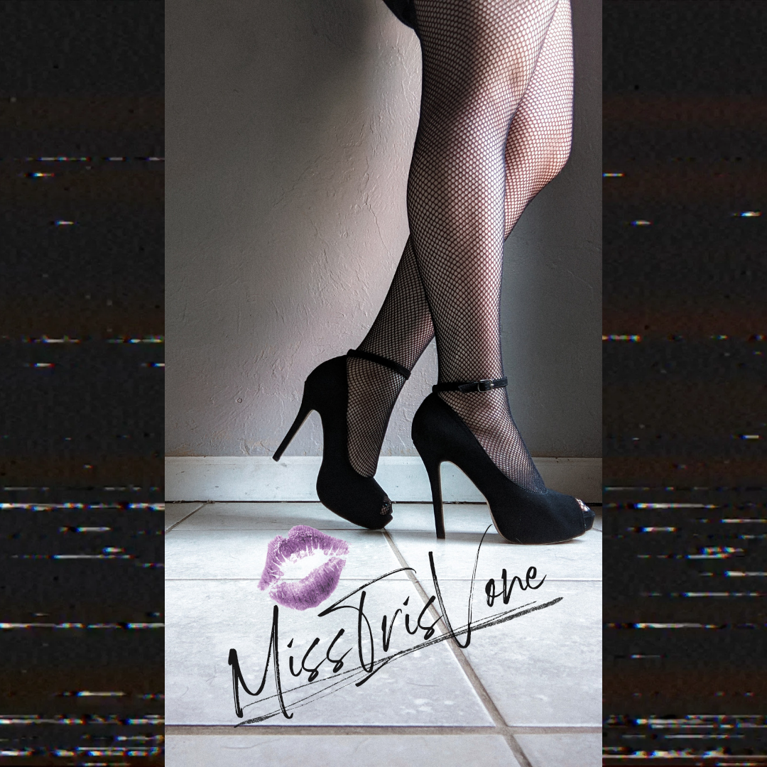 Miss Iris Vone wearing worn Femdom heels in a power pose.