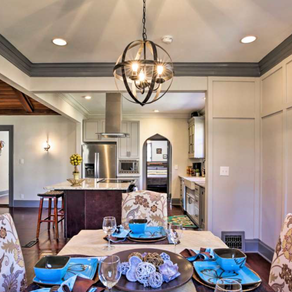 This island has a different color wood to accent the grey bottom and top cabinets.