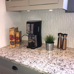 Granite Countertops and beautiful white vertical backsplash for simplicity.