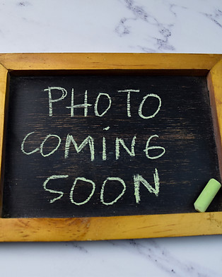 Photo Coming Soon write on a chalkboard isolated on wooden table