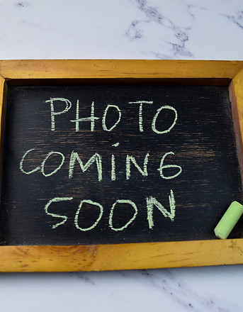 Photo Coming Soon write on a chalkboard isolated on wooden table