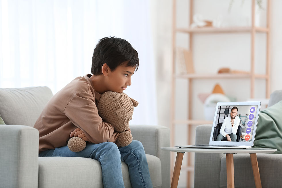 Little boy video chatting with psychologist at home