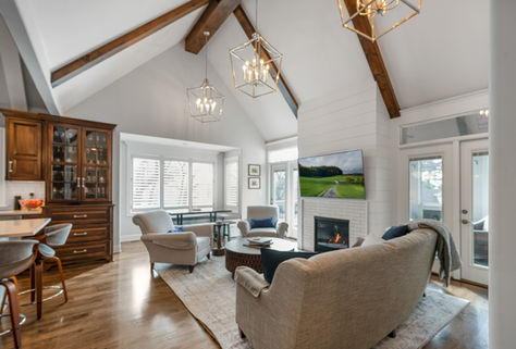Kansas City Real Estate photography of open living area with vaulted ceilings exposed beans and natural light 