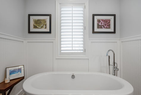 Kansas City real estate photography of modern bathroom featuring freestanding soaking tub, neutral walls and natural light