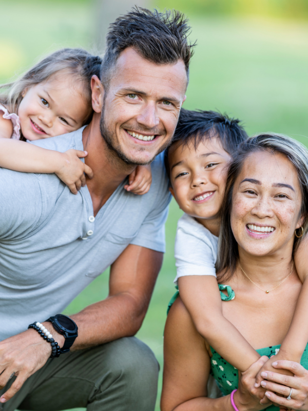 a family smiling together for a photo
