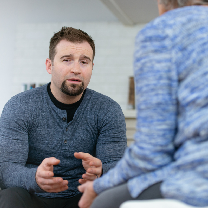 Male client discussing in therapy service