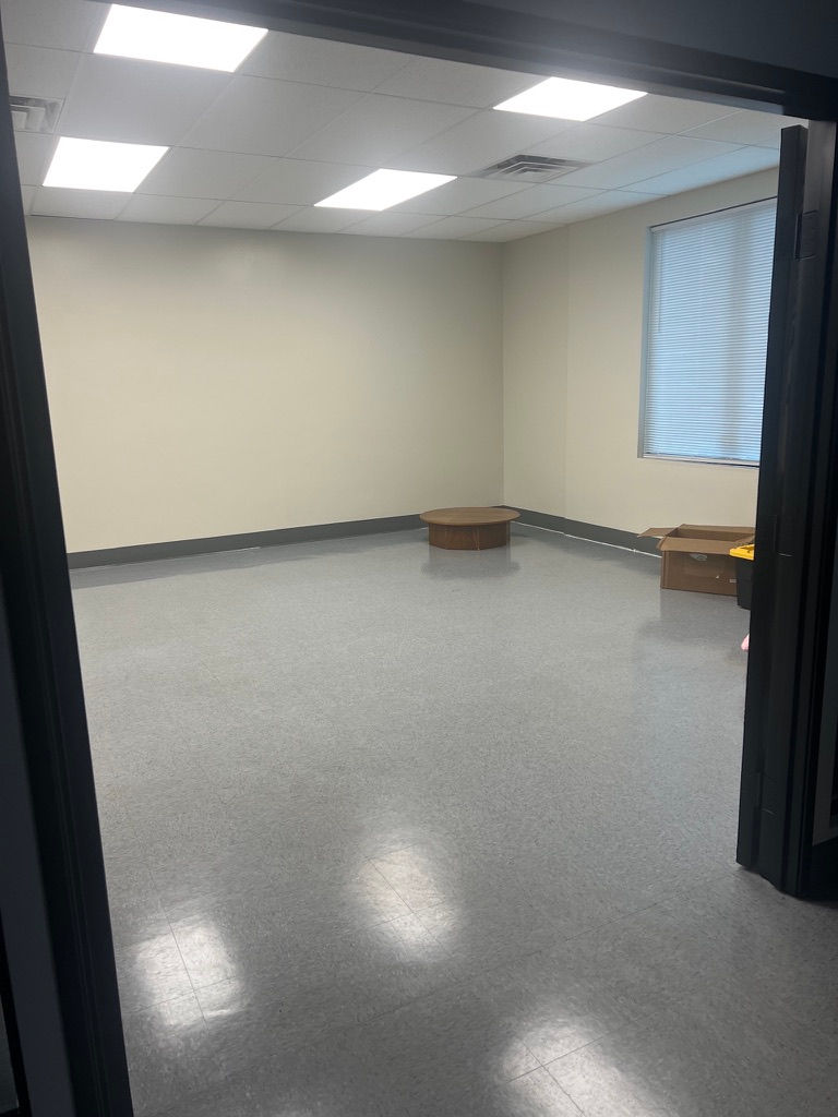 an empty room with a cardboard box on the floor