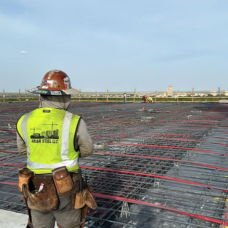 Beautiful sky on a high rise overlooking a post tension slab. Ariar steel admiring the quality of work done on the rebar and post tension cable. 