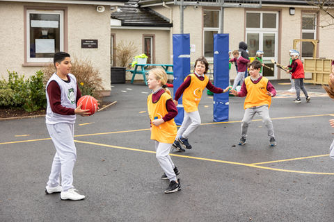 Students playing basketball outdoors at Killygarry National (Online Only do NOT Print)