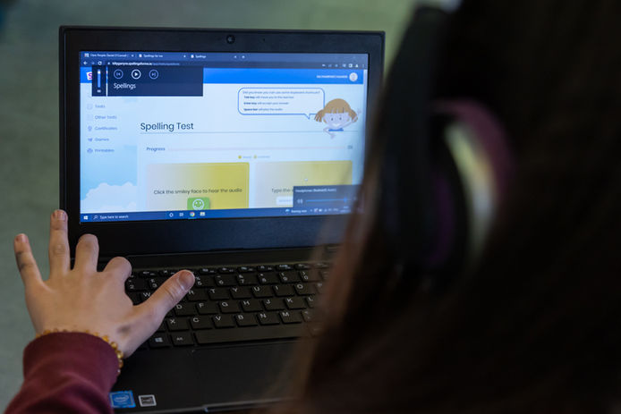 Student using a laptop, to do a spelling test (Online Only do NOT Print )

