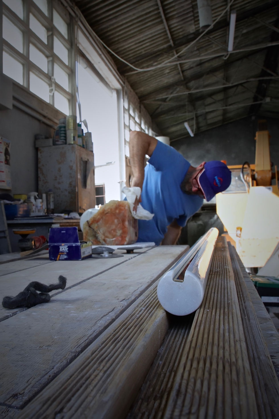 Artisan Emanuel works in his workshop in Lucca Italy polishing marble