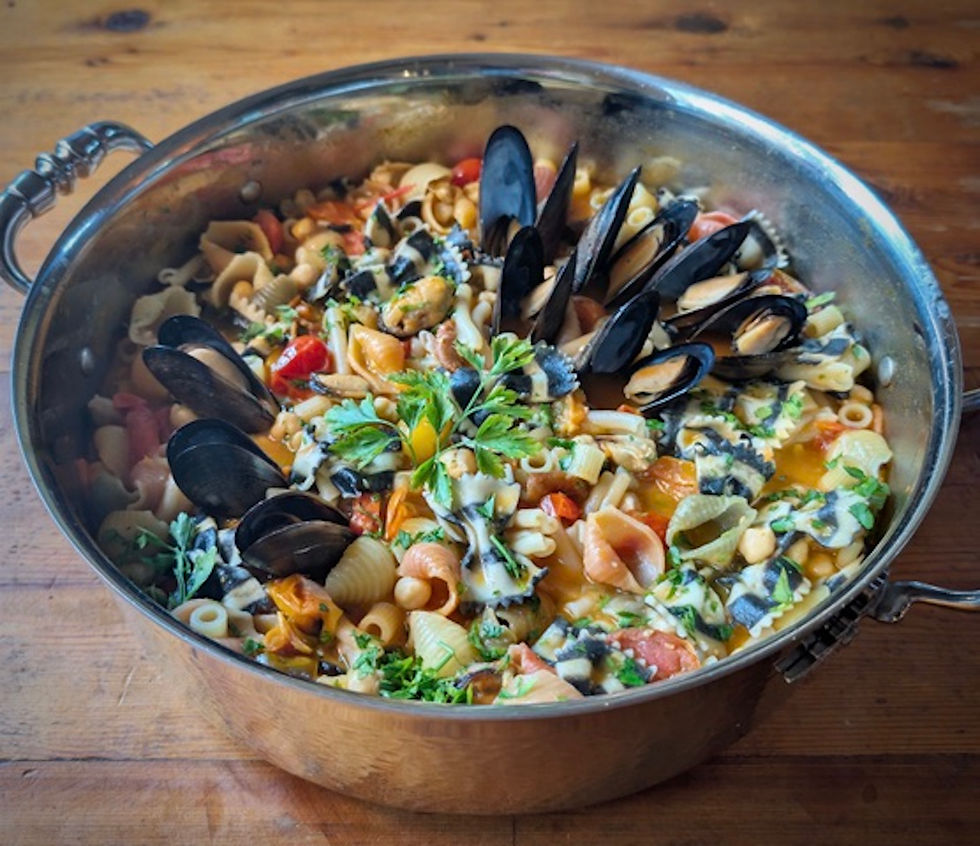 Neapolitan
Pasta Fagioli with chickpeas and mussels in a copper pot, on a rustic wood table.
