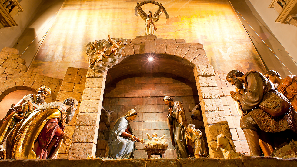 Italian Nativity Scene set in a church with stone walls, angels, and a large manger