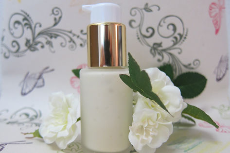 Bottle of lotion surrounded by flowers