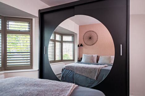 pink, modern bedroom with feature wardrobe