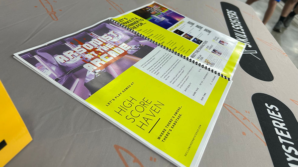 Open brochure on a table with a bright yellow page reading "HIGH SCORE HAVEN" and "WHERE THERE'S SMOKE… THERE'S SABOTAGE."