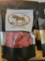 Black package labeled 'Freeze-Dried & Packaged Foods' by Moose Island Foods, with transparent section showing red, spherical items, likely freeze-dried berries. Label highlights origin ('Made in Wells, BC, Canada'), tagline ('Made Here... For You There...'), and partner ('Powered By Diggy's Golden Mercantile LTD').