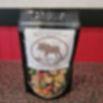 The image features a package of freeze-dried food labeled "Moose Island Foods," originating from Wells, British Columbia, Canada. The label includes phrases like "Made Here... For You There..." and "Powered by Diggy's Golden Mercantile Ltd." The package design includes a moose silhouette and has a transparent section to showcase colorful contents inside.