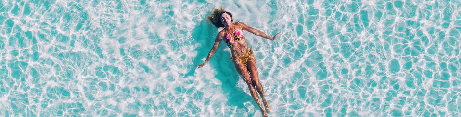 A woman floating in a pool.