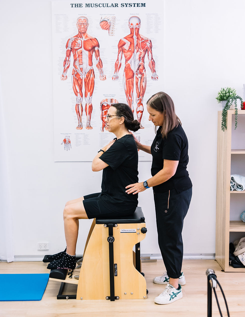 Physiotherapist and client doing Pilates exercises on split pedal chair