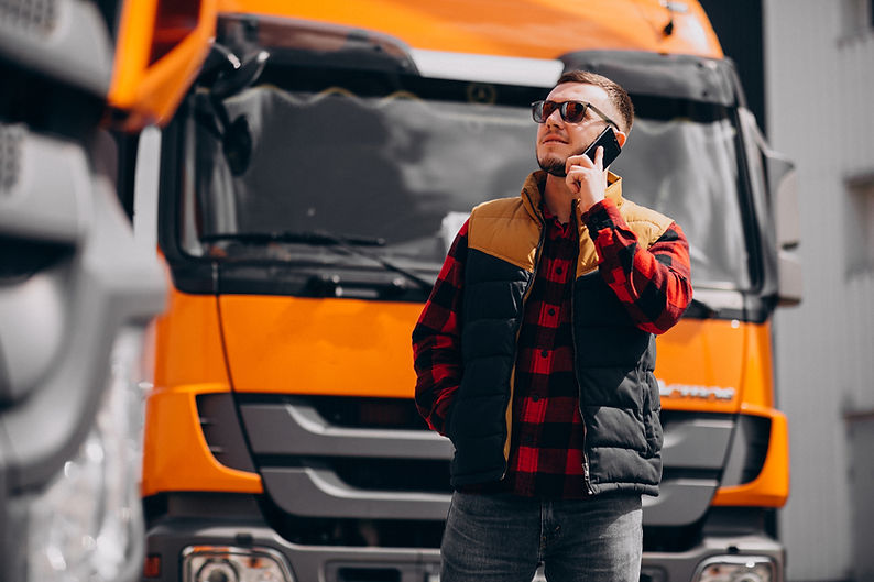 handsome-man-truck-driver-standing-by-truck.jpg
