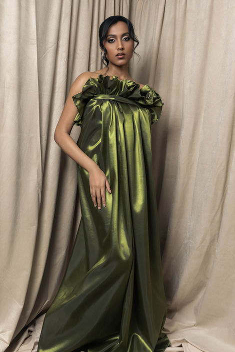 Sculptural fine art portrait of a model in a strapless olive green gown, featuring an avant-garde ruffled neckline and structured bodice for a luxury editorial photography experience