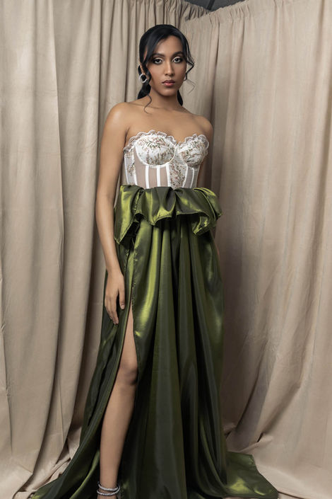 Bespoke white corset gown featuring dramatic hand-draped ruffles and a structured bodice, styled for a high-end glamour portrait session in a professional studio.
