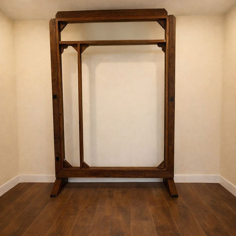 A wooden tufting frame in a small fiber art studio with cream walls and dark walnut floors.