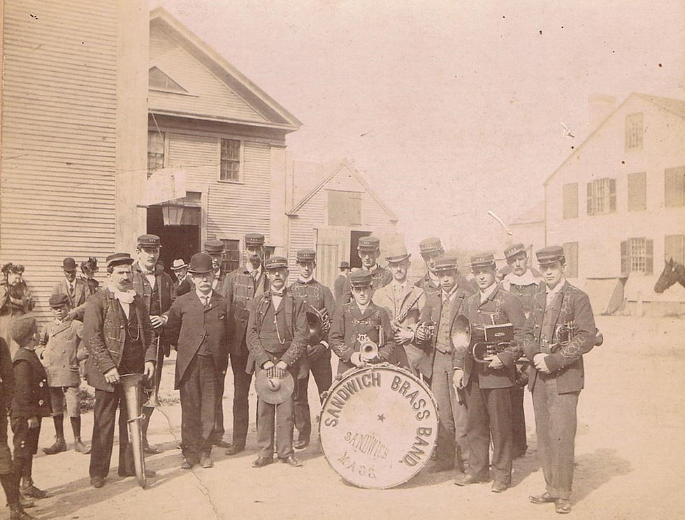 Sandwich Brass band standing in front of what is now the Dan'l Webster Inn. The Fessenden House is to he right.