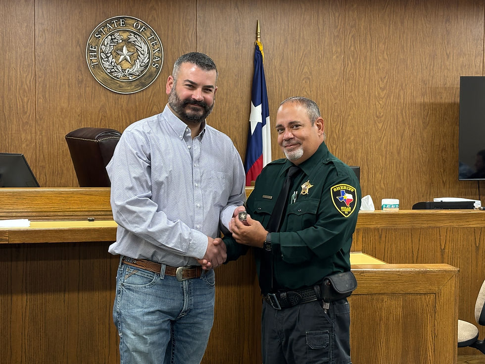 Nolan County Judge Whitley May presents Detention Officer Adrian Muynoz with his 5-year service pin.