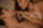 Attractive and sexy woman in bra touching lips of shirtless boyfriend on bed in vacation h