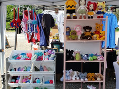 Charlie Brown-inspired crochet doll displayed on the top shelf of a craft fair booth