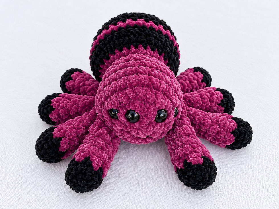 Colorful Spider - Bright purple and black crochet spider with four eyes and striped body.