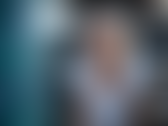 A smiling senior woman holding a tennis racket outdoors, representing recovery from brain cancer with cell therapy.