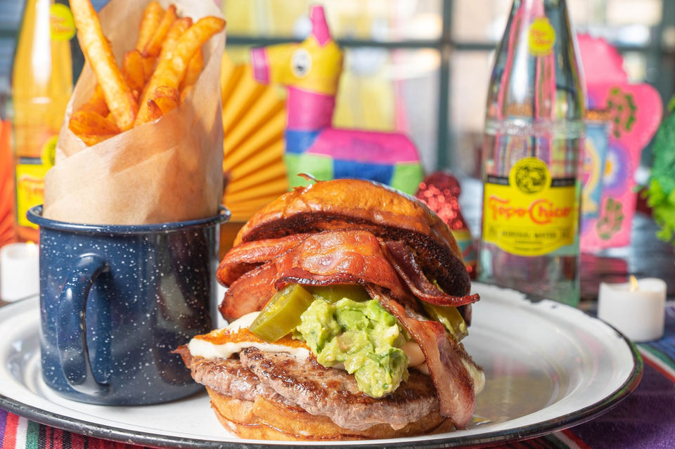 Signature burger with guacamole and queso panela at Broken English Taco Pub in Chicago’s Loop