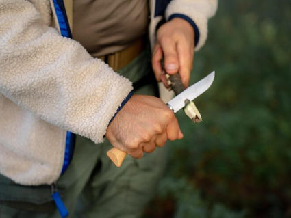 High-quality survival knife slicing wood