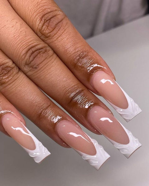 Long acrylic nails with white tips, French manicure design and clear polish.