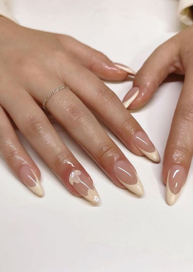 Woman's hands with white-tipped nails, elegant French manicure design.