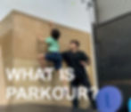 Parkour coach assisting a student with running up a wall.
