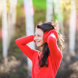 Dana in red sweater with colorful aspen background
