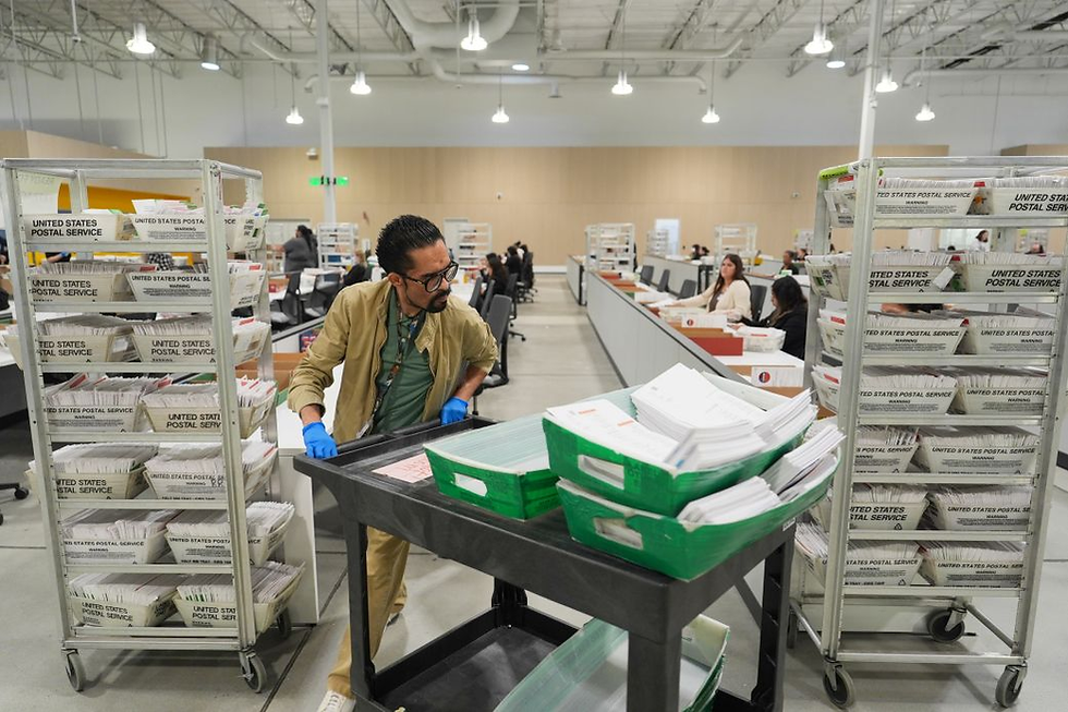 U.S. Postal Service workers process election mail at a sorting facility. (Fair use for news commentary) - Credit: cnn.com