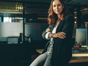 A confident female CEO sits in her office
