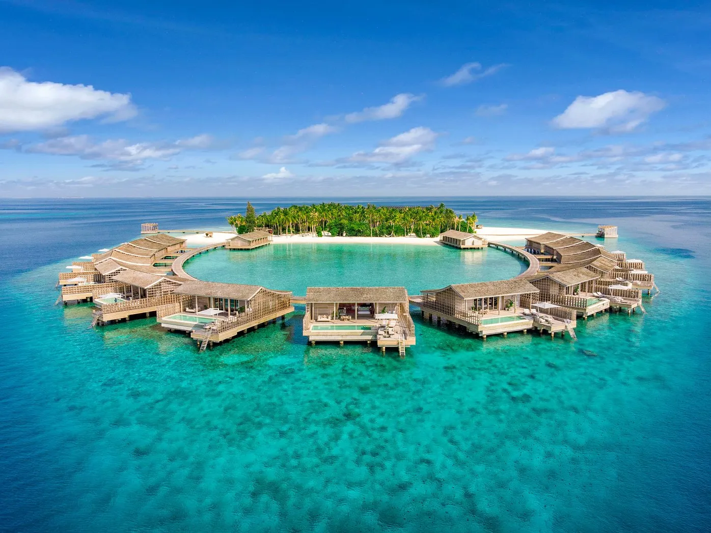 Private island luxury getaway with white sand beaches and overwater villas