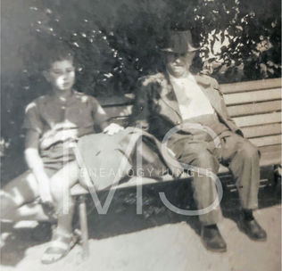 Boy and man on park bench, 1950s
