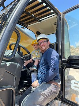 A picture of Chanina on a tractor with his son.