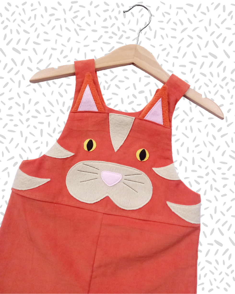 Children's Handmade Ginger Cat Dungarees for ages 0-6 years. Made from orange needlecord with touchy-feely facial features.