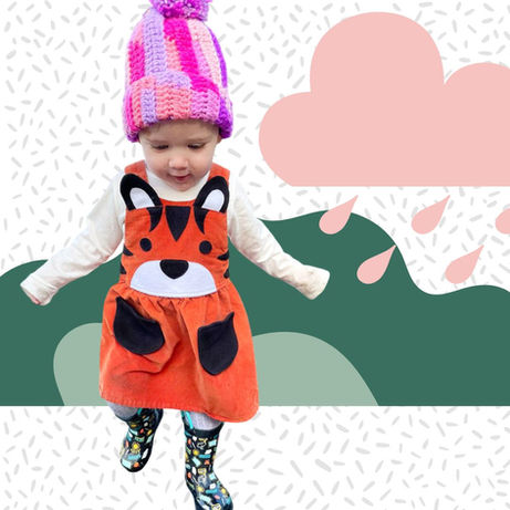 Girl's tiger orange needlecord pinafore dress for children aged 0-6 years.