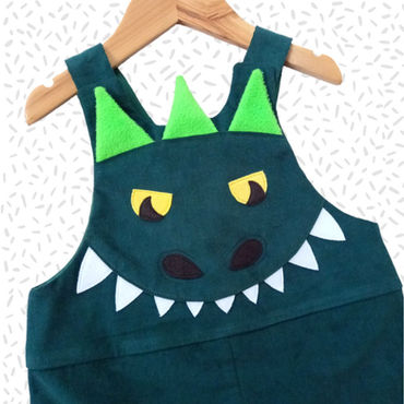 Children's handmade green needlecord rainbow dinosaur dungarees for ages 0-6 years.